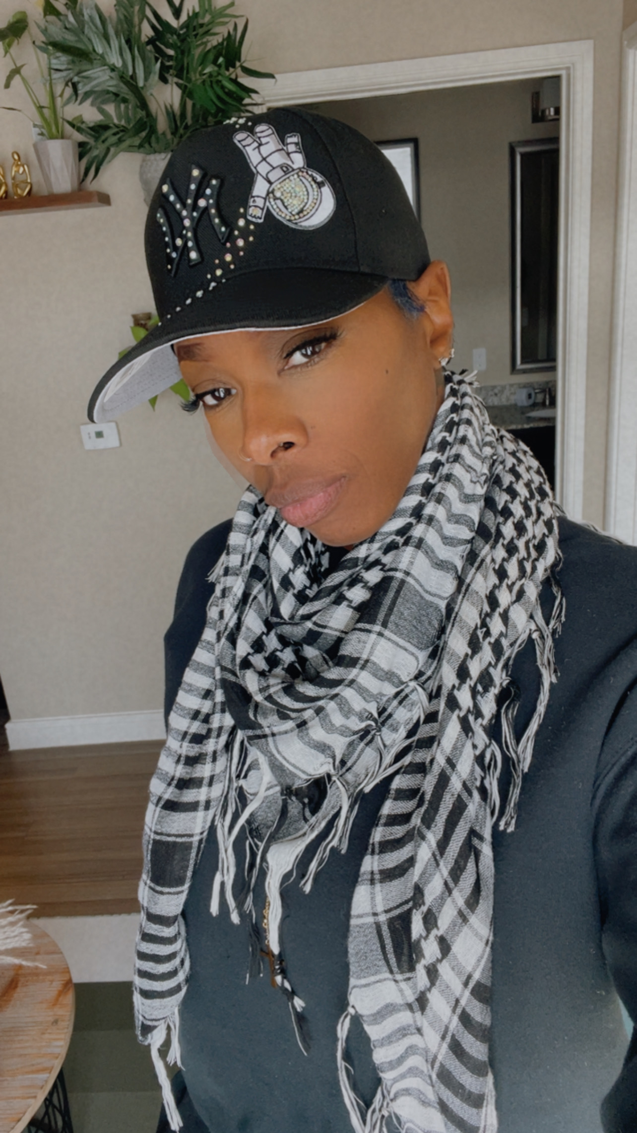 Anitra wearing a custom black crystal snapback